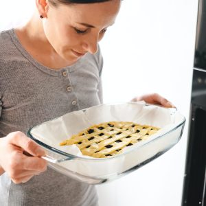 young-woman-puts-the-homemade-cake-in-the-oven.jpg